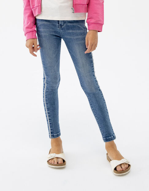 Blauwe skinny jeans microkraaltjes opzij meisjes