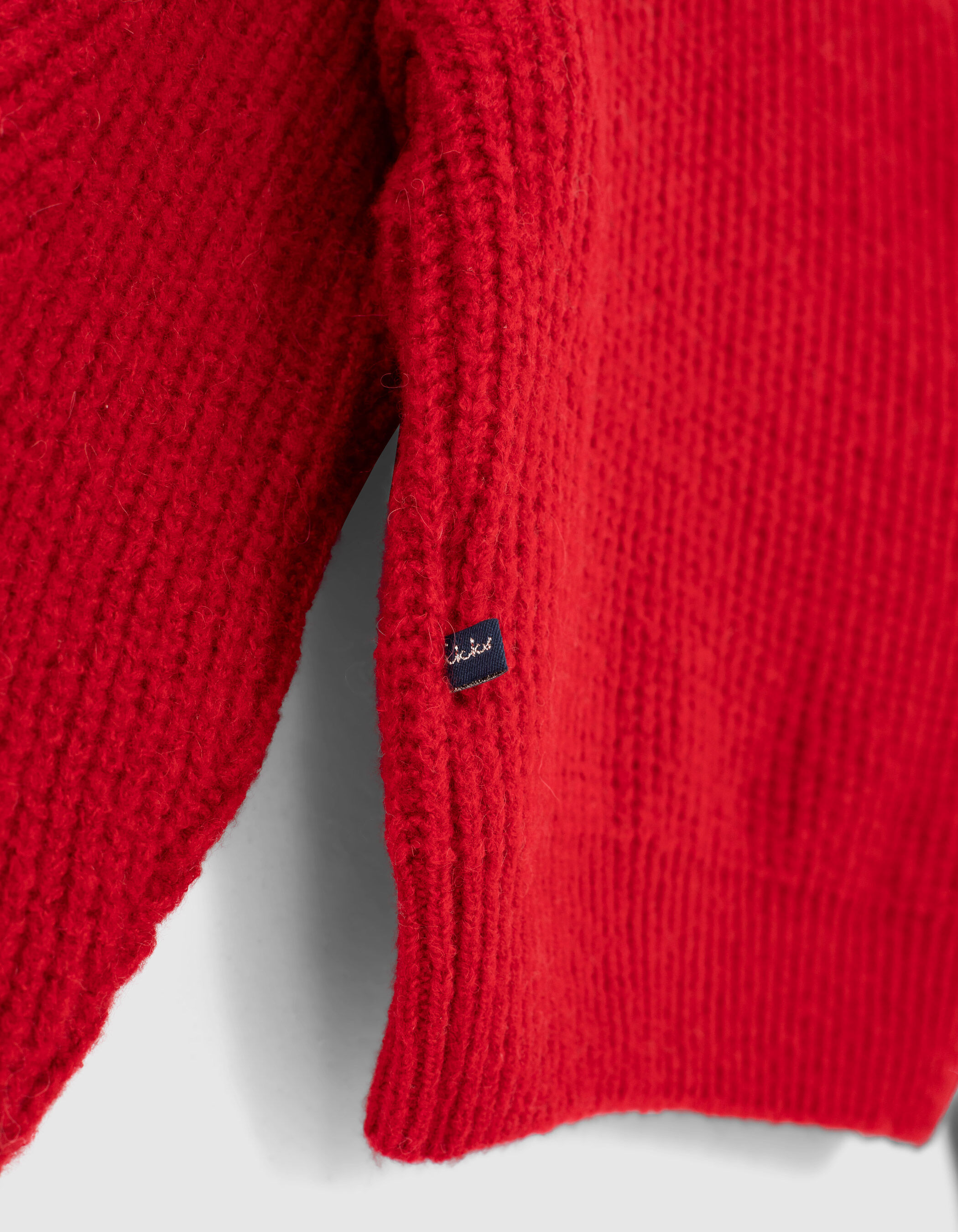 Girls light red knit sweater with ruffles