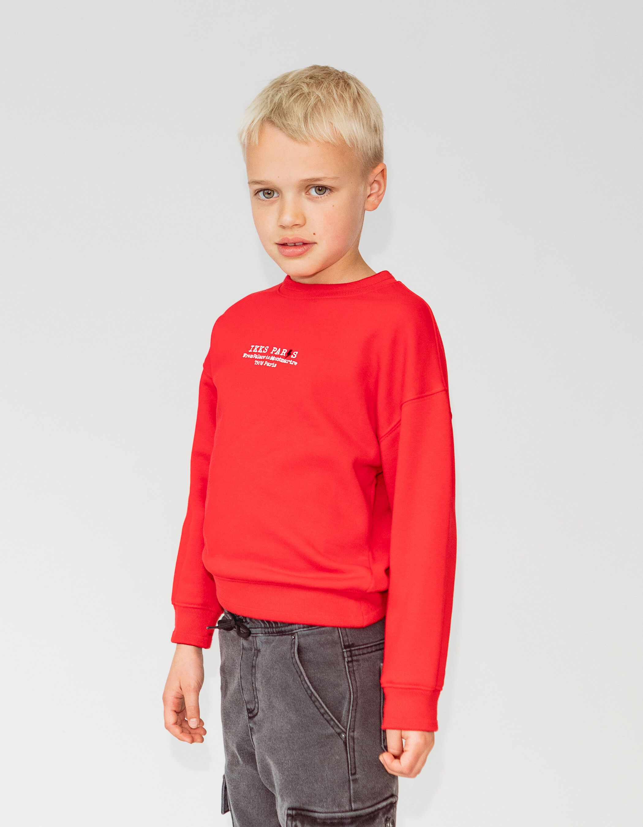 Boy s red fleece sweatshirt with embroidered message IKKS