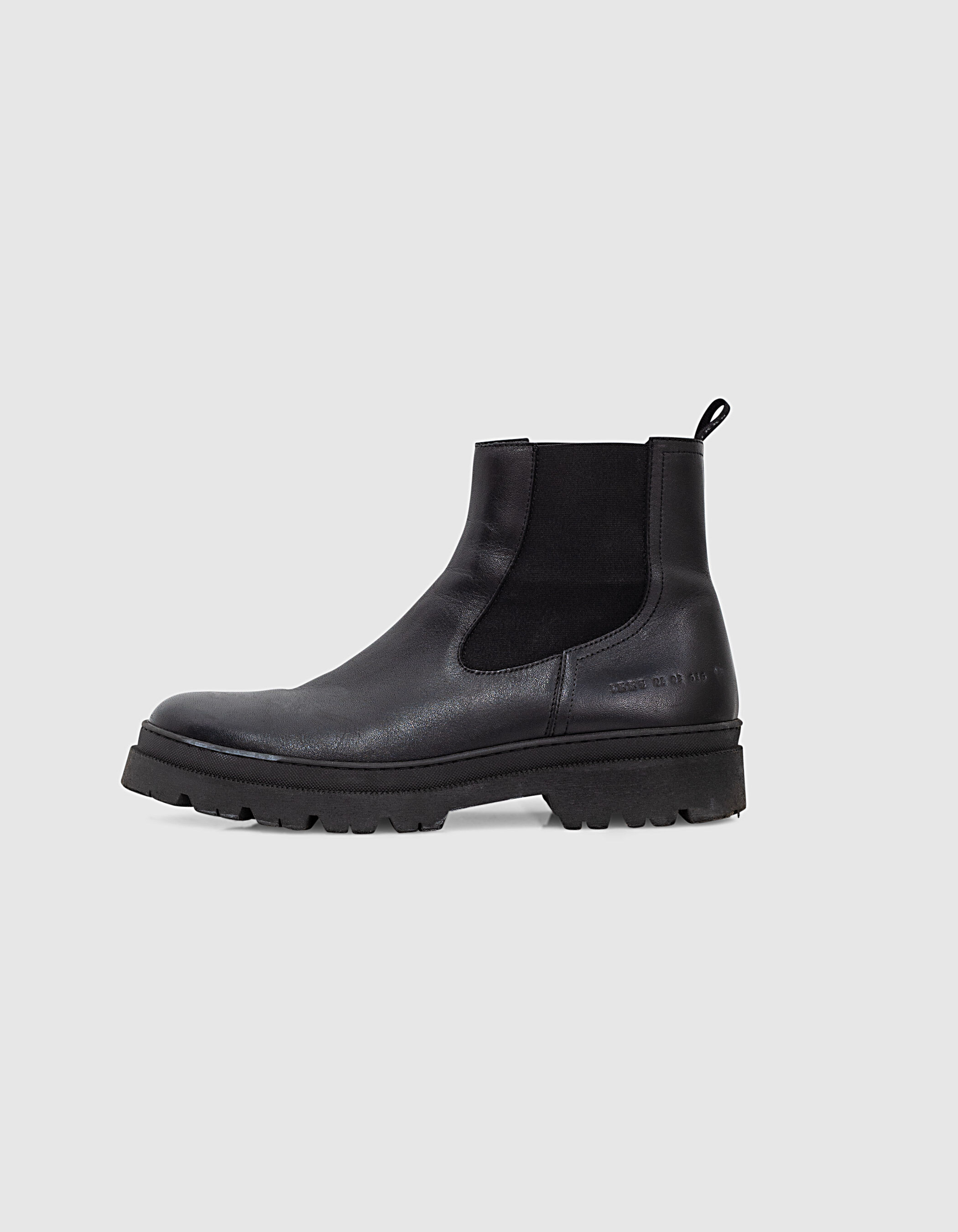 Men's black leather Chelsea boots with notched sole